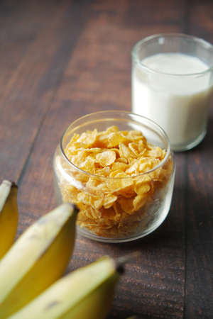 corn flakes , milk and banana on tableの写真素材