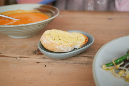 garlic bread , soup on a table