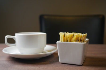 Sugar Substitute sweetener packet and tea cup on white backgroundの写真素材