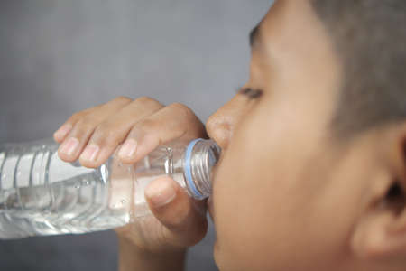 teenage boy drinking water slow motionの写真素材