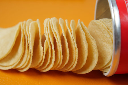 potato chips spilling form a packet on table