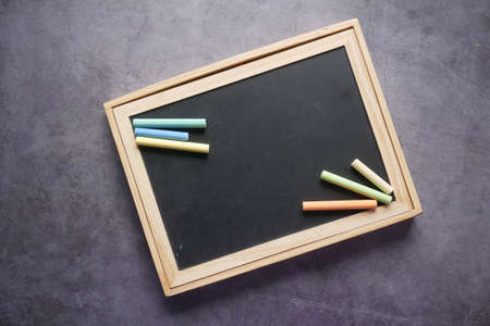 colorful chalk and chalkboard on black backgroundの写真素材