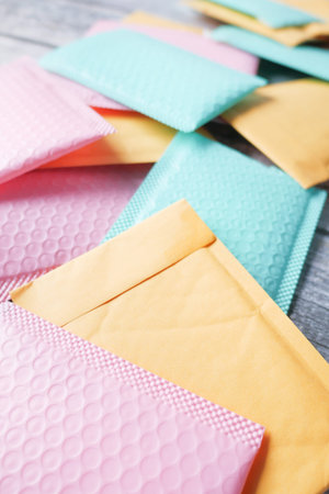 green and pink color paper bubble envelope on table