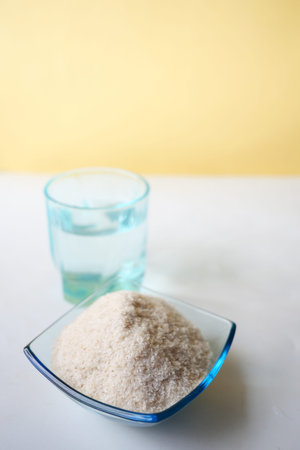 Psyllium Seeds in a glass container on table