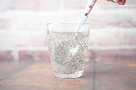 close up of chia seeds in a glass of waterの写真素材