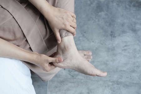 Close up on women feet and hand massage on injury spot.の写真素材