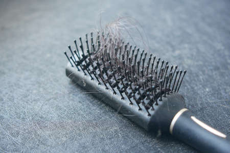 a brush with lost hair on tableの写真素材