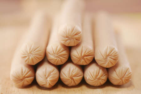 close up of stack of sausage on a wooden boardの写真素材
