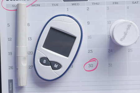 diabetic measurement tools on a calendar top viewの写真素材