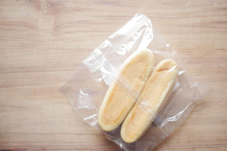 close up of baked bread in a plastic packet on tableの写真素材