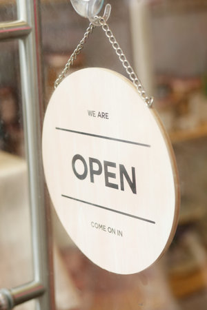 Open sign hanging front of cafe .の写真素材