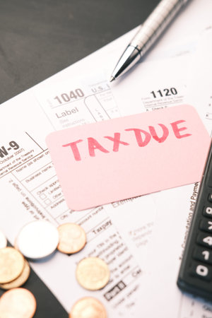 Tax return form and hand written tax due on table