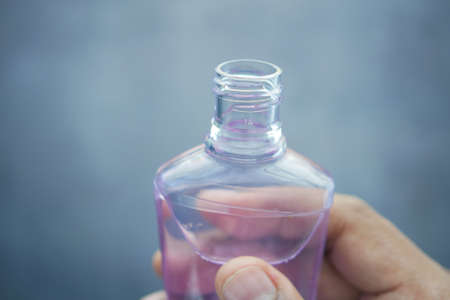 hand hold a mouthwash liquid containerの写真素材