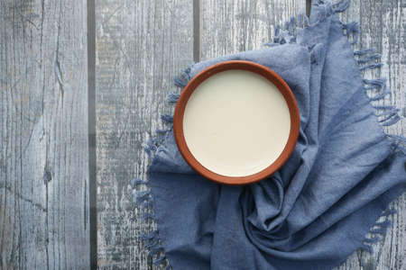 fresh yogurt in a bowl on tableの写真素材