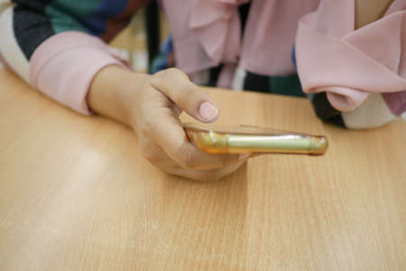 close up of women hand holding smart phoneの写真素材