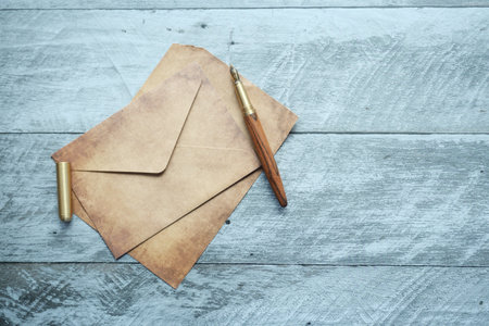 envelope , empty paper and fountain pen on tableの写真素材