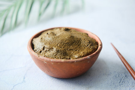 The wooden bowl with rehydrated henna on table