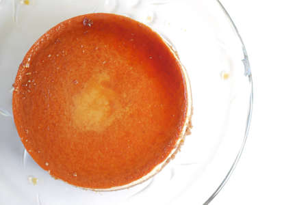 Caramel custard pudding on a plate on tableの写真素材