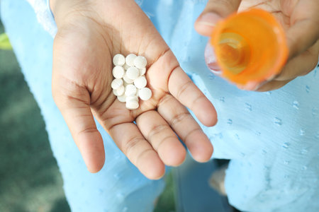 Close up of women hand taking pills