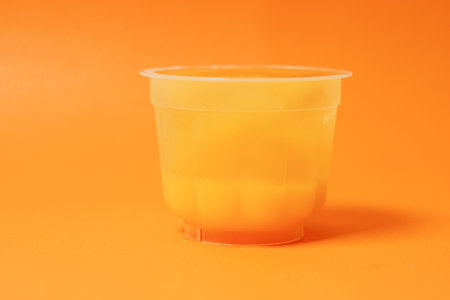orange jelly in a plastic containerの写真素材