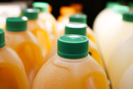 plastic bottle of orange juice in a shelfの写真素材