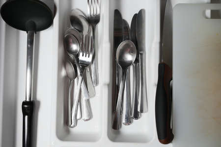 fork, knife and spoon on in a drawer top viewの写真素材