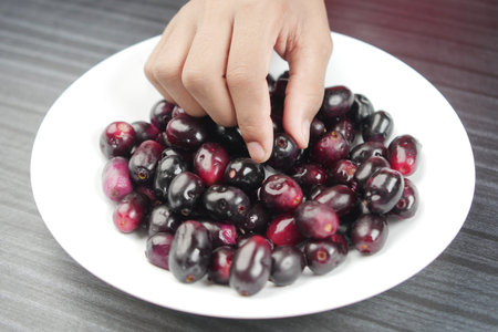 top view of black plum on a plate .の写真素材