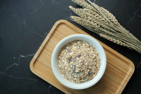 top view of granola Musli in a bowl on black backgroundの写真素材
