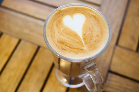 a cup of late coffee with heart shape design