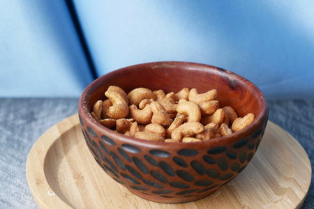 cashew nuts in a wooden bowl on tableの写真素材