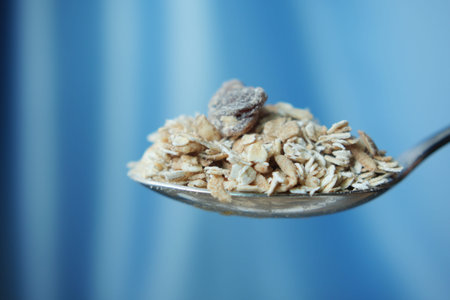 side view of oats flakes on a spoon
