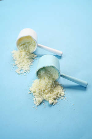 Close up of baby milk powder and spoon on tile background.の写真素材