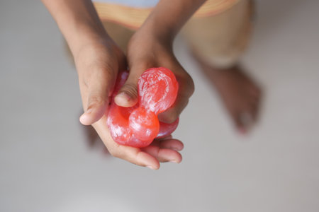 child Hand holding pink color slimeの写真素材