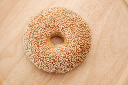 fresh bagel bread in a paper on tableの写真素材