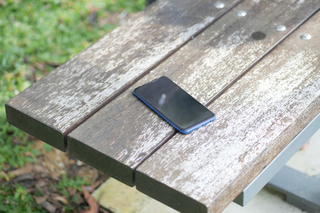 forget smartphone on a park bench, lost smart phoneの写真素材