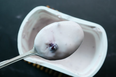 fresh yogurt on a spoon top view