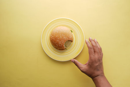 hand holding beef burger on table close upの写真素材