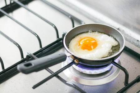 Fried eggs in the pan close up ,の写真素材