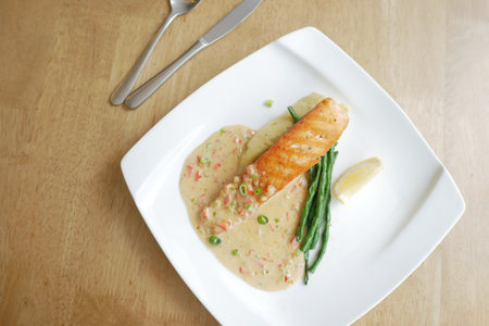 tasty salmon, mash potato and vegetable on plateの写真素材