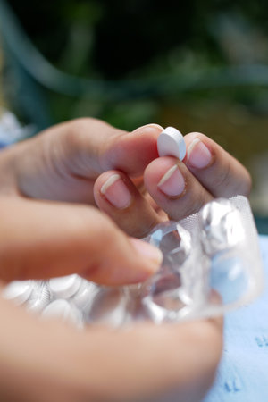 Close up of hand holding blister packs .の写真素材