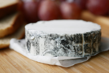 fresh goat cheese and grape fruit on wooden background.