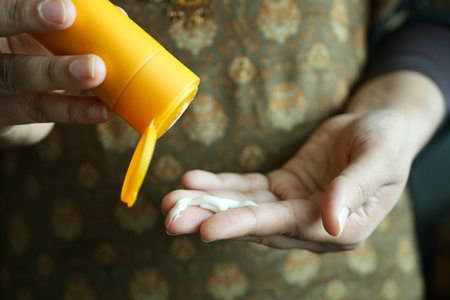 women hand using sunscreen creamの写真素材
