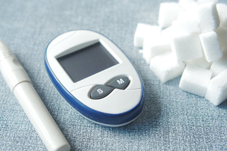 Close up of diabetic measurement tools and pills on color backgroundの写真素材