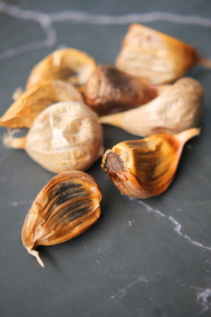 close up pf black garlic on white background tableの写真素材