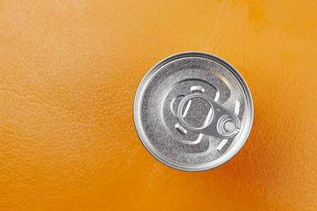 close up of a food can on orange background ,