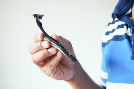 man holding Razor isolated on whiteの写真素材
