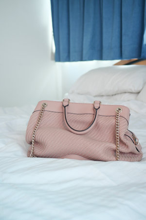 women purse wallet on bed, close up.の写真素材