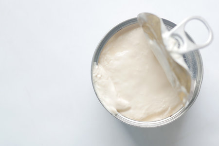 top view of milk cream in a tin container on tableの写真素材