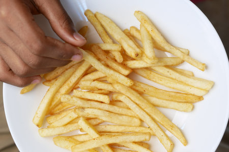 top view of hand pick french Fries on table