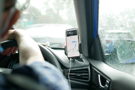 Singapore 12 may 2022. taxi driver using goggle map on smart phone